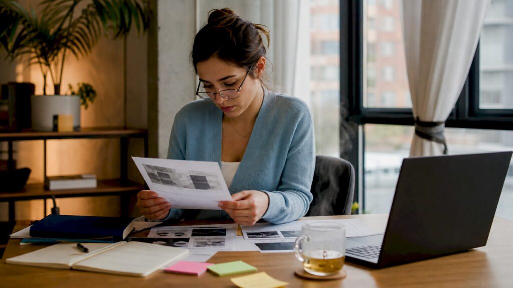 Woman reviewing printed content theft evidence