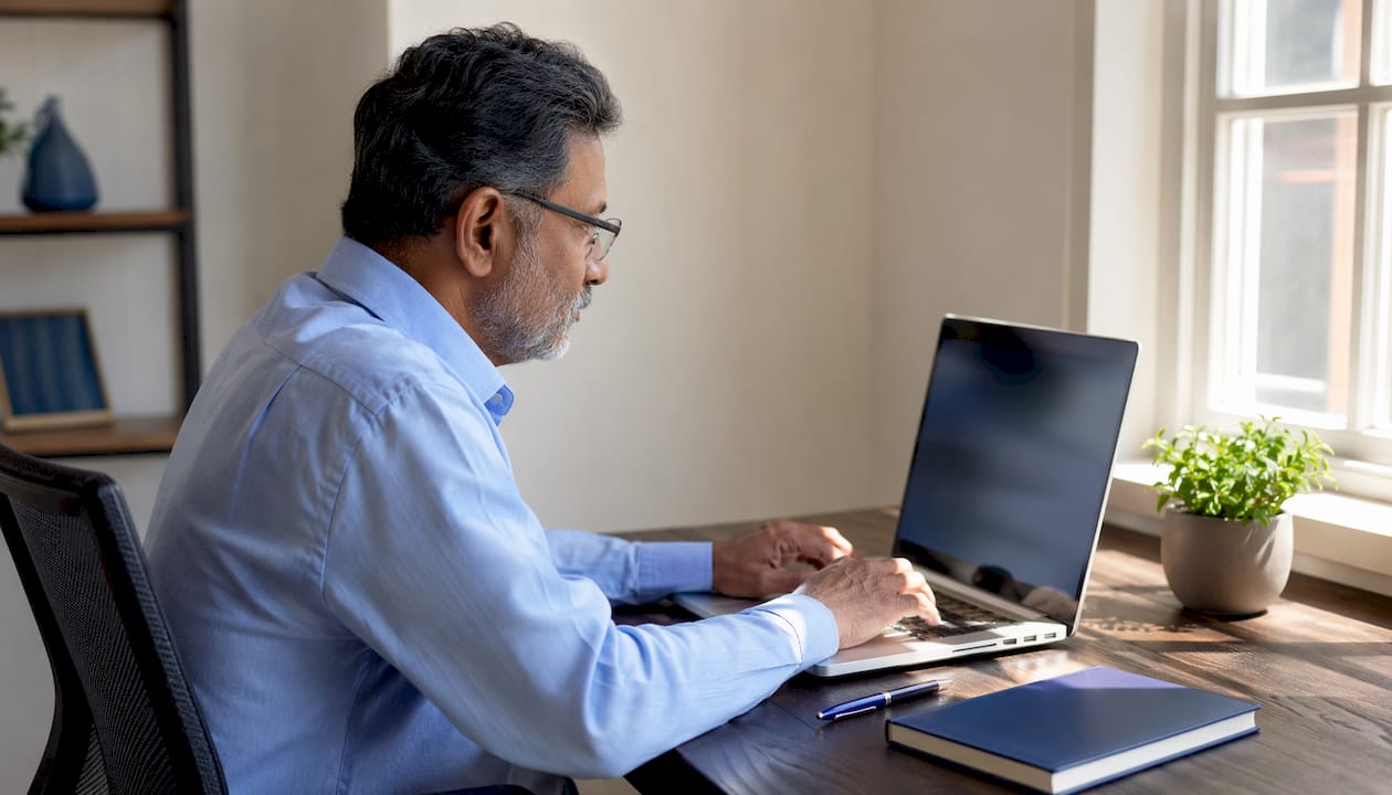 Hands typing on laptop in medical office setting