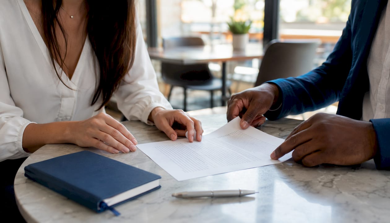 Hands reviewing confidentiality agreement